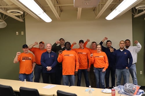 Group of Liuna members with their fists in the air. 