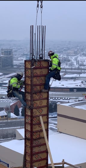 Laborers Reberto Brown and Zac Robles with Kelleher 18 stories up on a 18 column in downtown Mpls