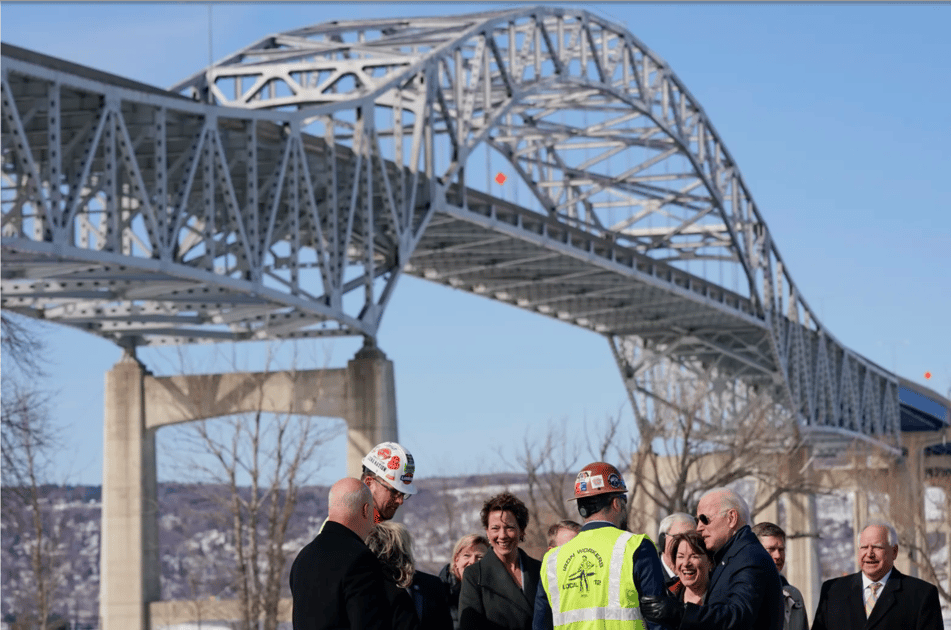 President Joe Biden visits the John A. Blatnik Memorial Bridge that connects Duluth, Minn., to Superior, Wis., Wednesday, March 2, 2022, in Superior, Wis. Sen. Amy Klobuchar, D-Minn., stands next to Biden and Minnesota Gov. Tim Walz is at right. (AP Photo/Patrick Semansky)