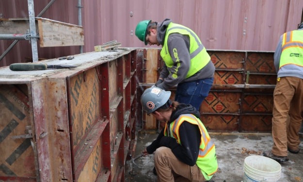 Construction workers building a fence.